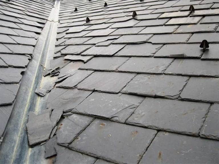 Slate roof with dislodged tiles