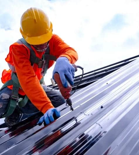 A contractor working on a metal roof.