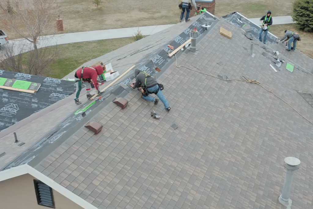 Apex Restoration & Roofing crew members working on a roof.